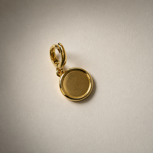 A Make Savage Gold Tone Black Enamel Charm Seen from the back